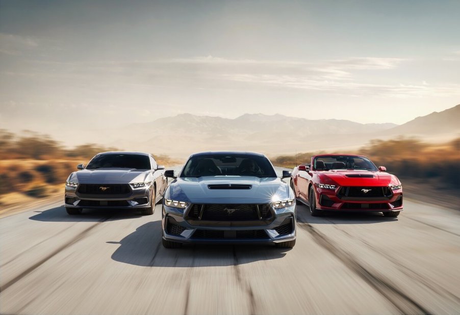 A set of 2024 Ford Mustang EcoBoost and GT Convertibles and Coupes drive on an open road.