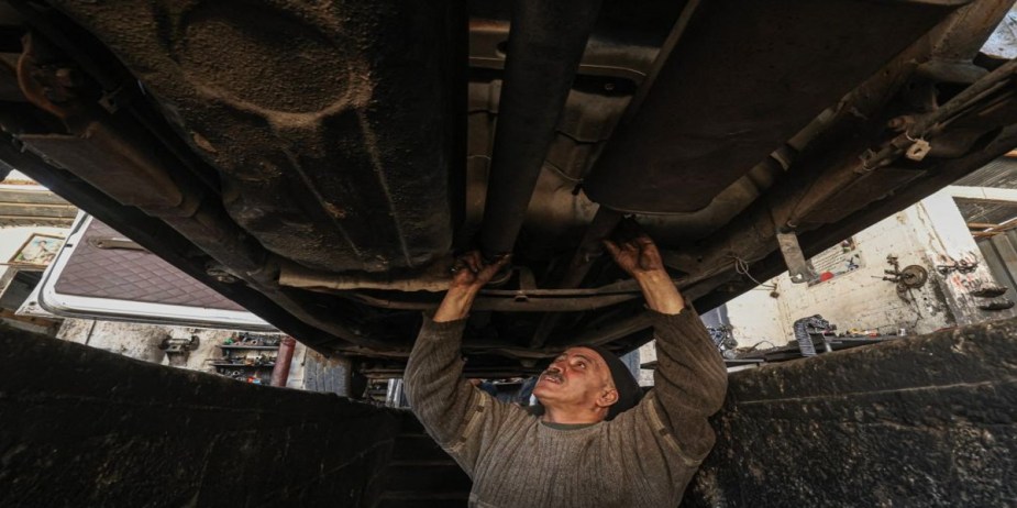 Mechanic working under a vehicle. 