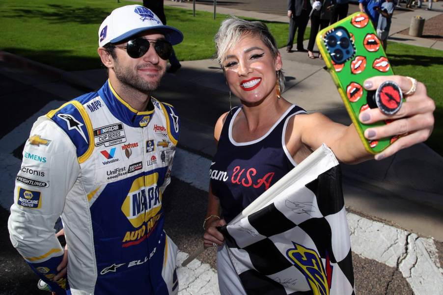 NASCAR fan takes a selfie with driver Chase Elliott during a race event.