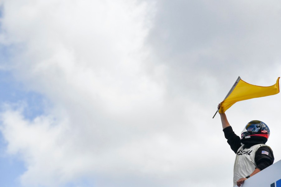 NASCAR official waves flag.