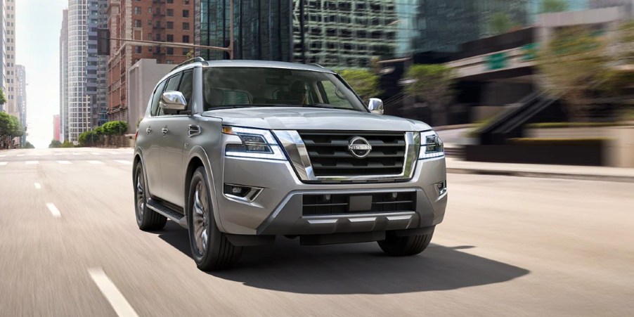 A gray 2023 Nissan Armada full-size SUV is driving on the road.