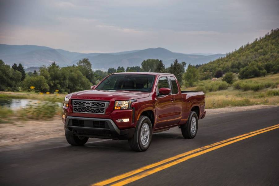 A Nissan Frontier driving down the road.