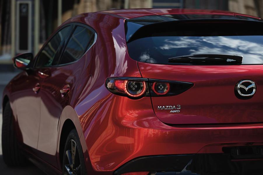 A red Mazda3 Hatchback on display.