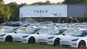 Tesla electric cars on display at a dealership.