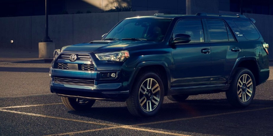 A blue Toyota 4Runner midsize SUV is parked in a parking lot. 