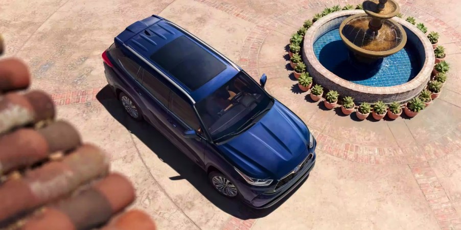 An aerial view of a blue 2023 Toyota Highlander midsize SUV parked near a fountain.