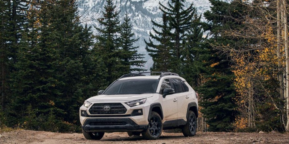 A white Toyota RAV4 small SUV is parked. 