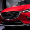 A red Mazda CX-3 grill up close at an auto show. Used Mazda CX-3 reliability is an important factor to consider.