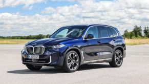 A promotional image of the redesigned BMW X5 midsize luxury SUV model on an asphalt lot