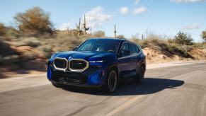 The first-ever BMW XM luxury plug-in hybrid electric vehicle SUV model in Marina Bay Blue Metallic