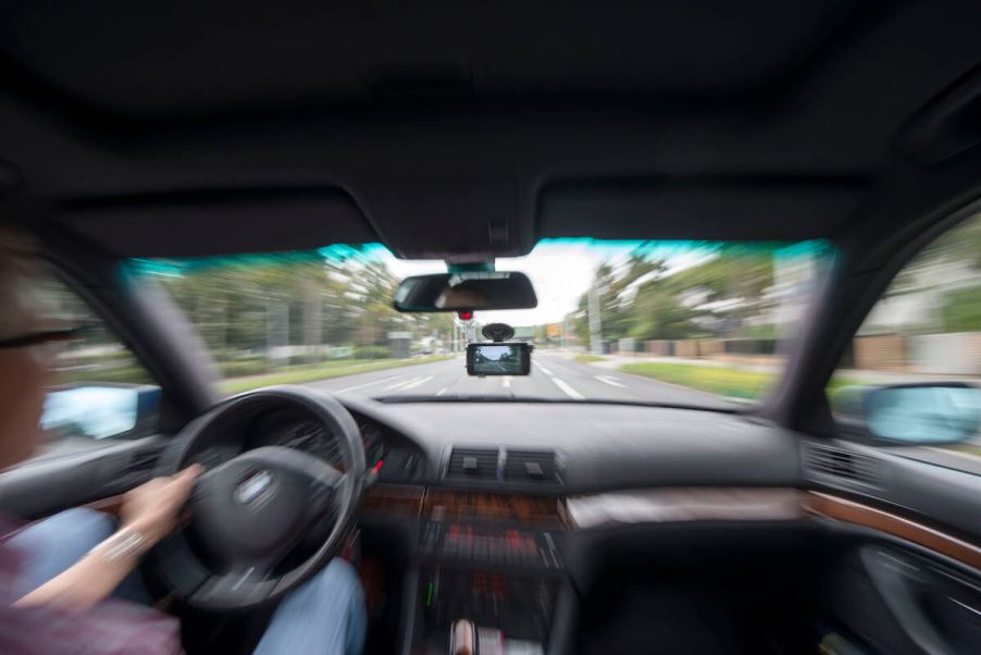 A view out of a windshield from a car being driven