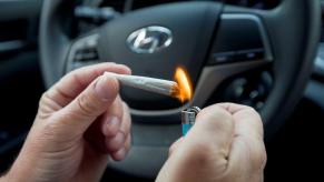 A driver in a Hyundai car lighting a marijuana cigarette to symbolize drug driving laws