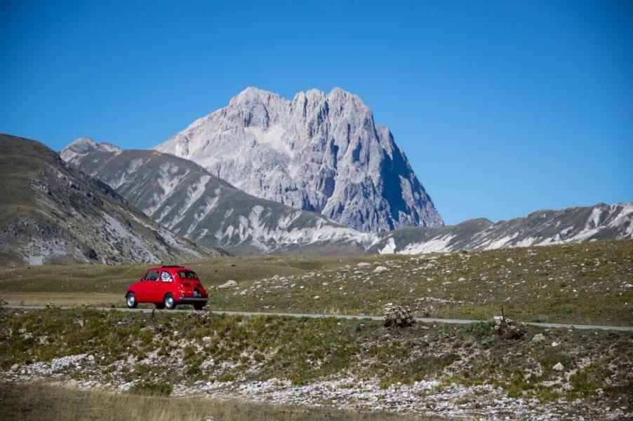 A singular Fiat 500 model driving near the Apennine Mountains in Campo Imperatore, Italy