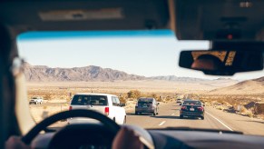 People driving in a rental car on a road trip