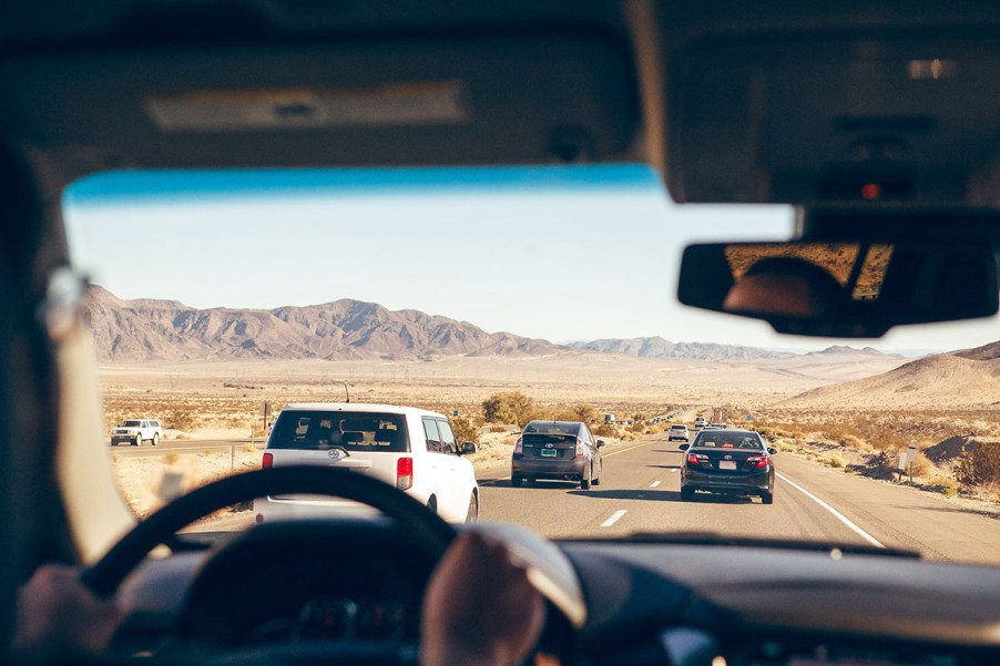 People driving in a rental car on a road trip