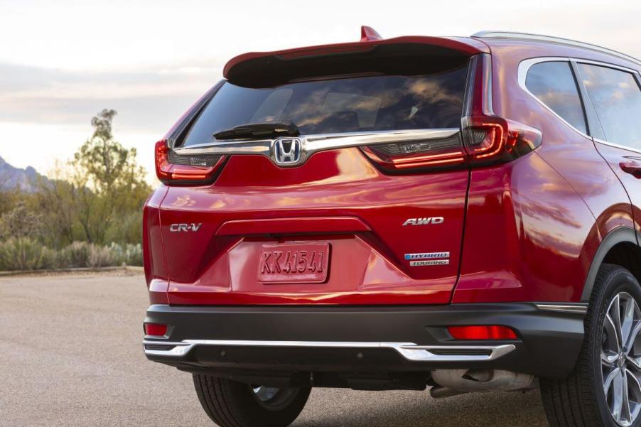 An exterior rear shot of a 2023 Honda CR-V Hybrid Touring AWD model where a spare tire is found in the trunk