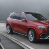 A 2024 Mercedes-Benz AMG-GLS SUV full-size luxury SUV driving on a twisting, foggy highway road