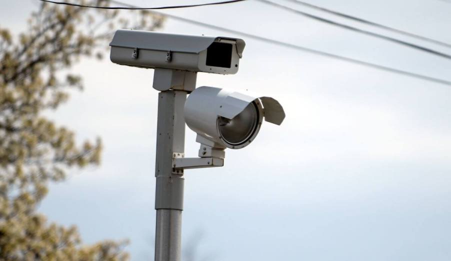 A red light camera on a corner catching speeding driver in Commack, New York on Long Island