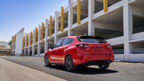 A rear shot of a 2024 Subaru Impreza RS all-wheel drive (AWD) hatchback model near a parking garage