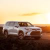 A 2024 Toyota Grand Highlander Limited midsize SUV model parked in the wild as the sun sets behind it