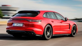 Red 2023 Porsche Panamera Sport Turismo on the track