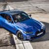 Overhead shot of blue 2023 BMW M4 parked on a racetrack.