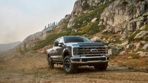 A 2023 Ford Super Duty F-250 Tremor off-road performance heavy-duty pickup truck near mountain cliffs