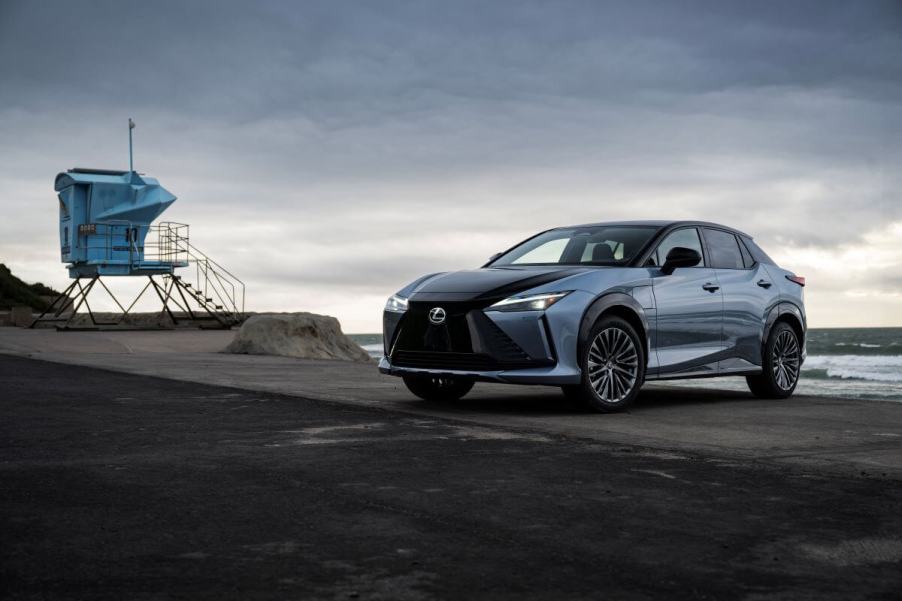 A 2023 Lexus RZ 450e Luxury all-electric SUV model in Ether Black parked on an overcast beach