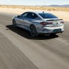 A rear view of the 2024 Acura TLX driving