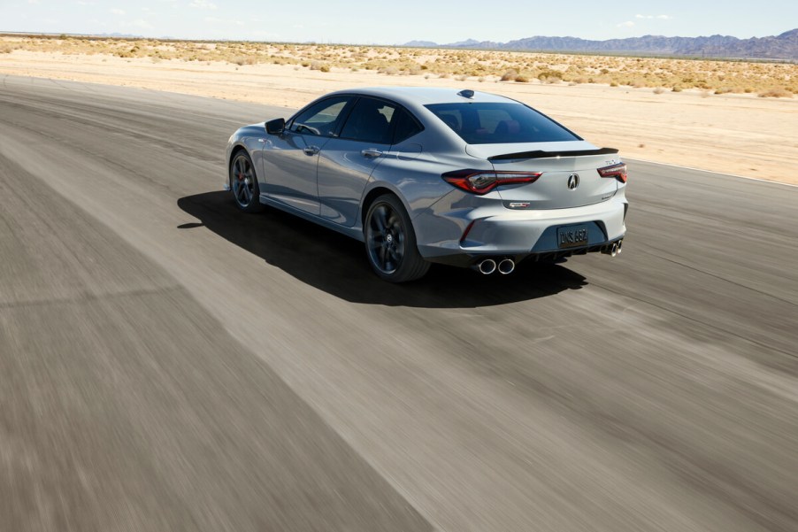 A rear view of the 2024 Acura TLX driving