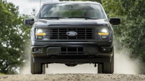 The 2024 Ford F-150 off-roading on a dirt trail