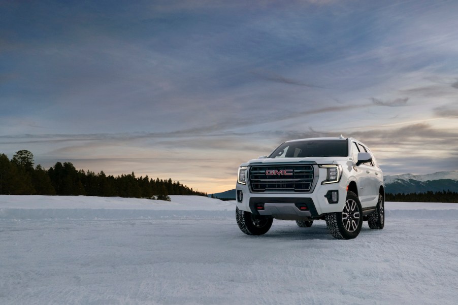 2023 GMC Yukon AT4 driver front 7/8 view on snow.