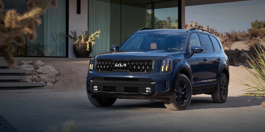 A blue 2024 Kia Telluride midsize three-row SUV is parked. 