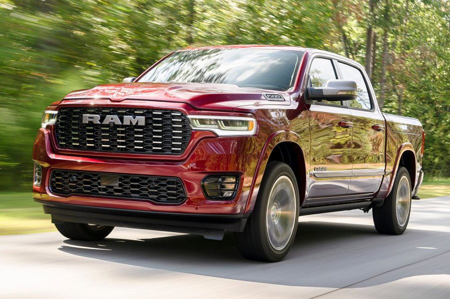 Red Ram 1500 pickup truck driving down the road.