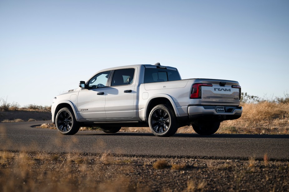 White 2024 Ramcharger electric pickup truck EV parked on a paved road.