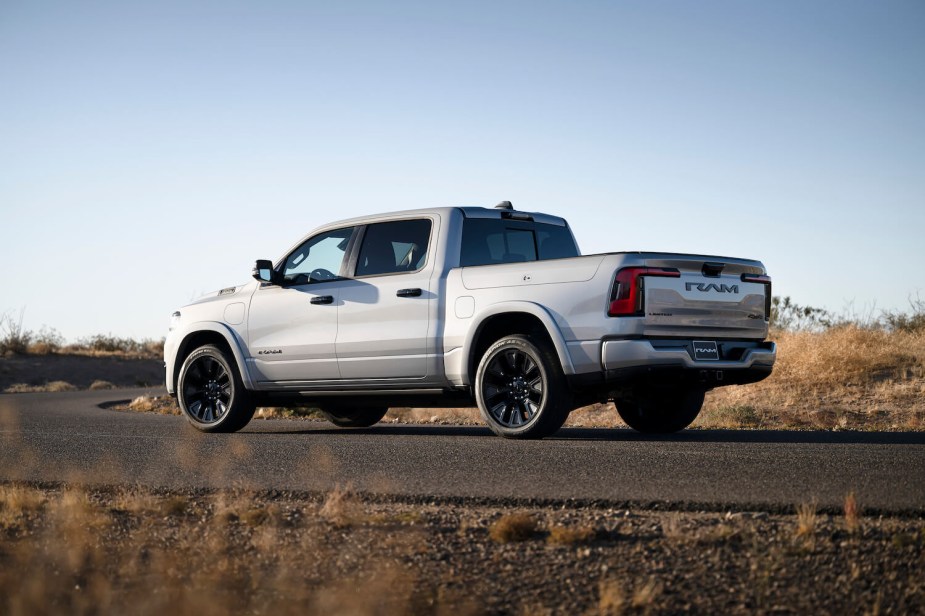 Silver Ram 1500 electric pickup truck parked in a desert.