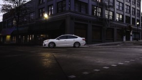 White Subaru Legacy driving in the city. It takes a bit of cash to buy a 2023 Subaru Legacy, but it might be worth the investment.