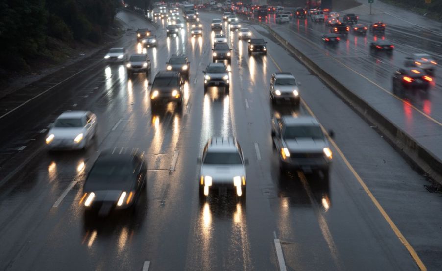 Cars cruising on the highway on a rainy day.