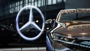 The Mercedes-Benz logo on the glass of a Daimler-AG showroom of MB luxury cars in Berlin, Germany