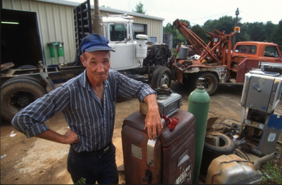 Man with gas pump at gas station