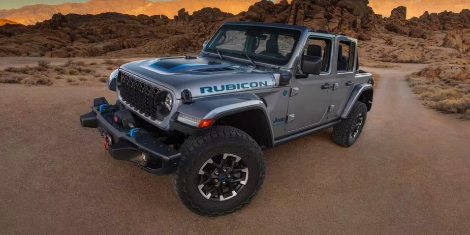 A gray Jeep Wrangler 4xe small electric SUV is parked outdoors. 