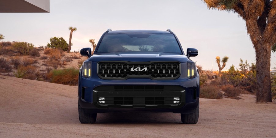 A blue 2024 Kia Telluride midsize three-row SUV is parked.