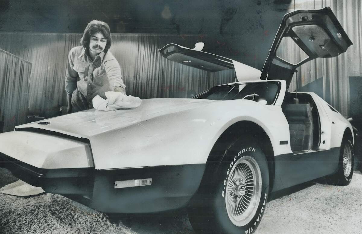 Malcolm Brickton with his gullwing Bricklin SV-1 in 1975