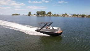 An action shot shows a 22' Manitou Explore pontoon boat on its way to a Falcon 9 rocket launch.