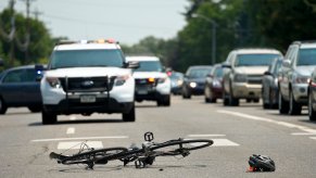 Smashed bicycle after being hit by a pickup truck in a pedestrian lane.