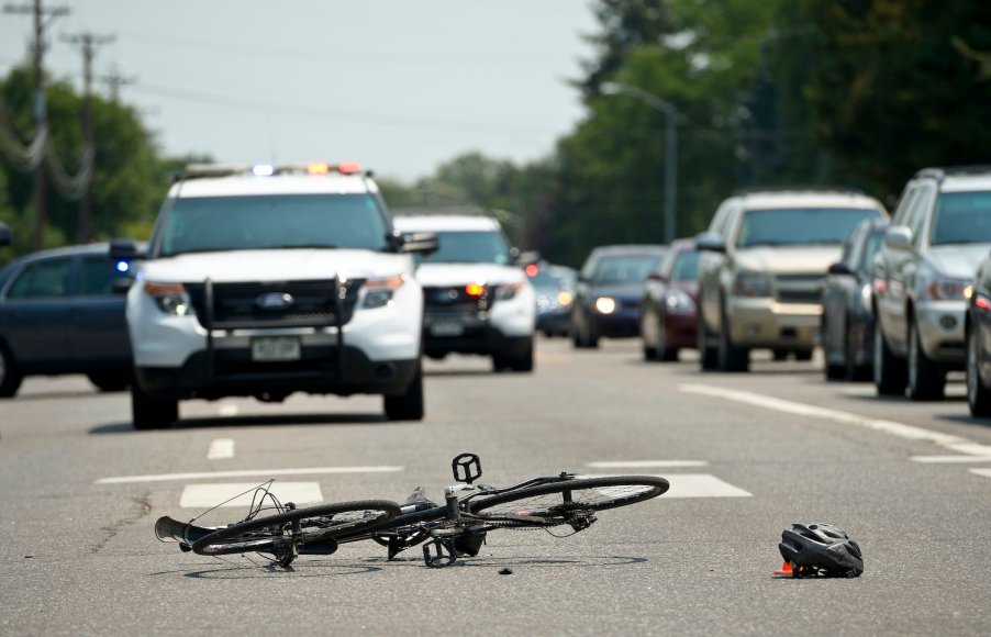 Smashed bicycle after being hit by a pickup truck in a pedestrian lane.