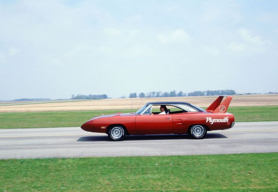 A Plymouth Superbird driving on an open road.