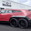 Red 6x6 Lamborghini Urus SUV with black fender extensions