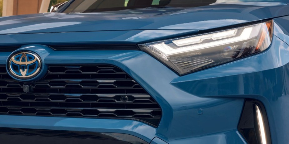 The front of a blue Toyota RAV4 Hybrid small hybrid SUV. 