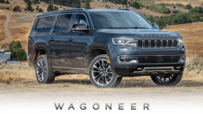 A promotional photo of a 2024 Jeep Wagoneer full-size luxury SUV model on dry grass near farm fields